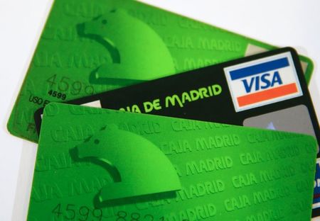 © Reuters. Credit cards issued by Spanish savings bank Caja Madrid are seen in this photo illustration