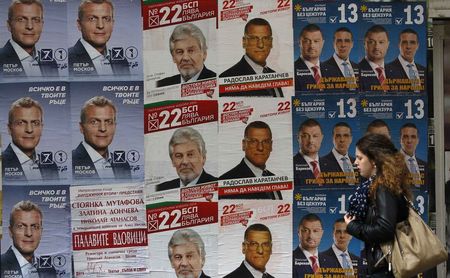 © Reuters. Woman walks past election posters in Sofia