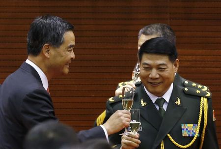 © Reuters. File photo of Hong Kong Chief Executive Leung toasting with Major General Tan of the PLA in Hong Kong