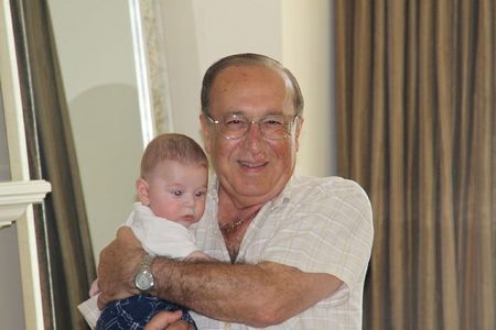 © Reuters. Undated handout photo of Canadian transport executive Cy Tokmakjian holding his grandson