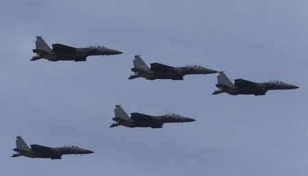 © Reuters. South Korean Air Force F-15K fighter jets fly in sky during celebrations to mark 65th anniversary of Korea Armed Forces Day, in Seongnam