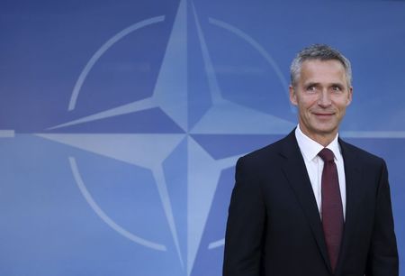 © Reuters. New NATO Secretary General Jens Stoltenberg of Norway poses as he arrives for his first day of work at the Alliance headquarters in Brussels