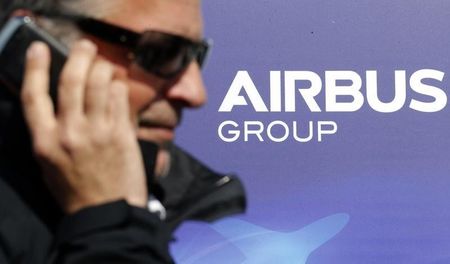 © Reuters. A man makes a phone call next to the logo of Airbus Group during the e-Aircraft Day at the Bordeaux Merignac airport