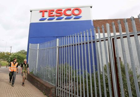 © Reuters. Pedestrians walk past a Tesco store in Bow, east London