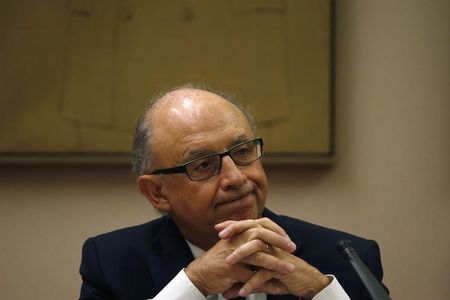 © Reuters. Spanish Treasury Minister Montoro listens to a question during a parliamentary commission in Parliament in Madrid