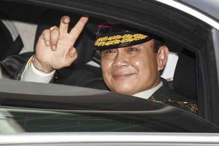 © Reuters. Thailand's Prime Minister Prayuth gestures to the media as he leaves after a handover ceremony for the new Royal Thai Army Chief, General Udomdej, at the Thai Army Headquarters in Bangkok