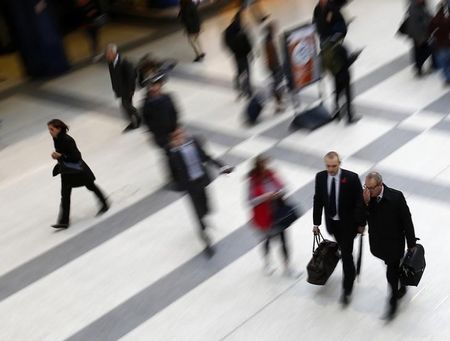 © Reuters. Workers walk through Liverpool Street station in London