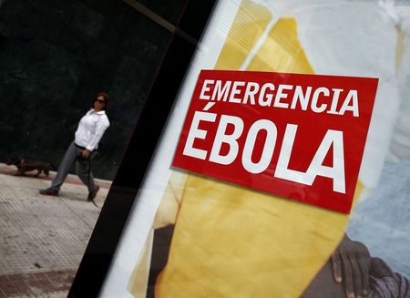 © Reuters. Advertisement for donations to fight Ebola in Africa is displayed on a bus stop near the apartment of a nurse who contracted Ebola near Madrid