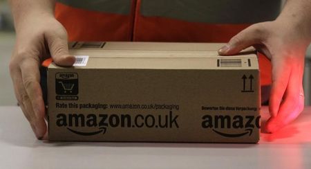 © Reuters. Worker handles items for delivery at Amazon's new distribution center in Brieselang