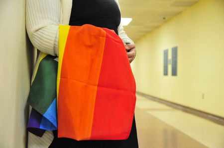 © Reuters. A supporter stands waits to congratulate gay couples as they receive their marriage licenses at the Oklahoma County courthouse in Oklahoma City