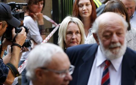 © Reuters. June Steenkamp and Barry Steenkamp, the parents of Reeva Steenkamp, arrive at the North Gauteng High Court in Pretoria