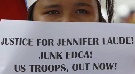 © Reuters. A student displays a placard during a protest rally against the killing of Laude, outside the U.S. embassy in Manila