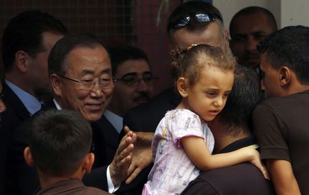 © Reuters. Palestinian man shakes hands with United Nations Secretary-General Ban Ki-moon during Ban's visit to a UN-run school in Gaza City