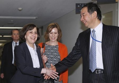 © Reuters. Acting Deputy U.S. Trade Representative Cutler shakes hands with Japan's deputy chief negotiator Oe ahead of their meeting for the TPP free trade negotiation, at the Foreign Ministry in Tokyo