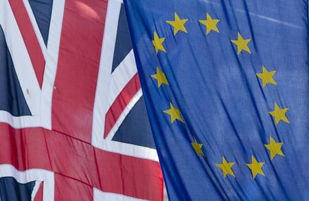 © Reuters. The Union Flag flies next to the European Flag outside the European Commission building in central London