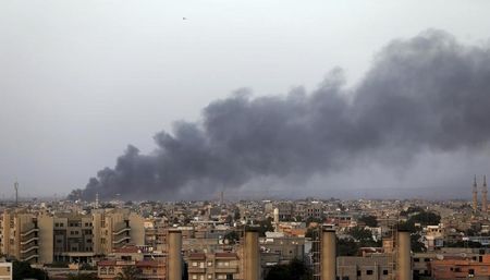 © Reuters. Plumes of black smoke is seen after clashes in Benghazi