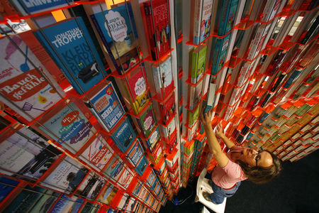 © Reuters. A woman sorts books at a booth during preparations for the upcoming book fair in Frankfurt