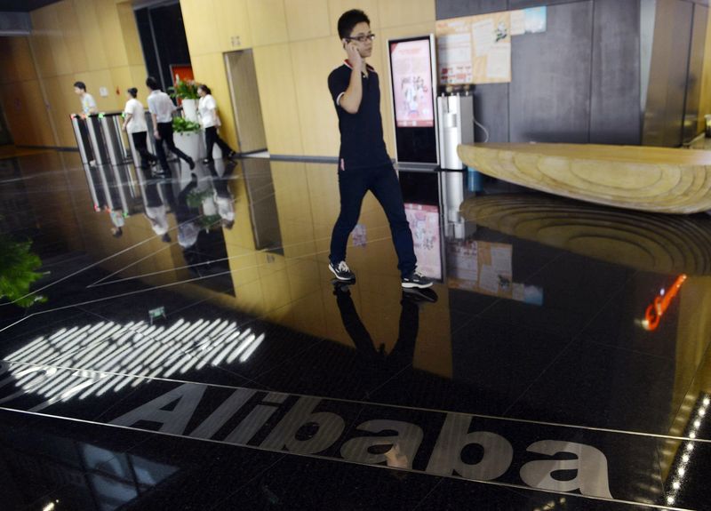 &copy; Reuters Man walks past a logo of Alibaba Group on the floor, at the company's headquarters on the outskirts of Hangzhou