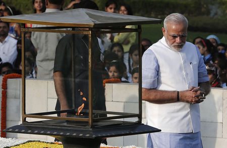 © Reuters. India's Prime Minister Modi walks after paying homage at the Mahatma Gandhi memorial on the 145th birth anniversary of Gandhi at Rajghat in New Delhi