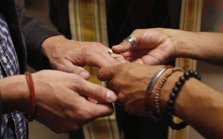 © Reuters. Jim Derrick and Alfie Travassos exchange rings as they get married at the Salt Lake County Government Complex in Salt Lake City, Utah