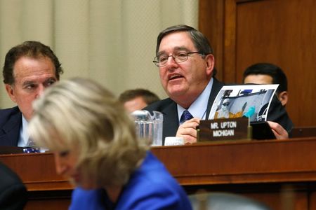 © Reuters. Burgess holds a photo of Frieden in protective gear in West Africa as Frieden testifies before a House Energy and Commerce Oversight and Investigations Subcommittee hearing on the U.S. response to the Ebola crisis, in Washington