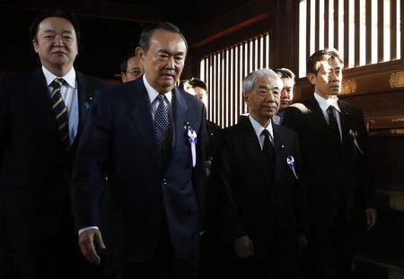 © Reuters. A group of lawmakers including Japan's ruling Liberal Democratic Party lawmaker Otsuji are led by a Shinto priest as they visit Yasukuni Shrine in Tokyo