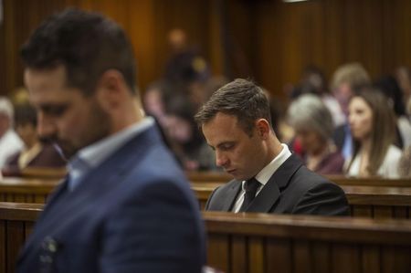 © Reuters. Olympic and Paralympic track star Oscar Pistorius attends his sentencing hearing at the North Gauteng High Court in Pretoria