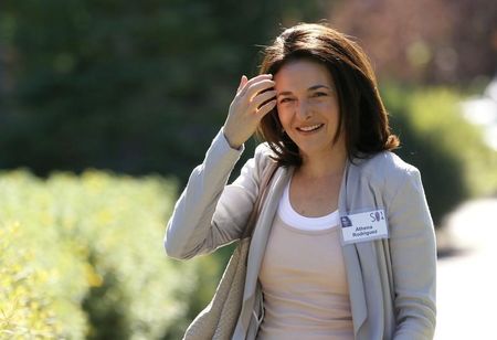 © Reuters. Sheryl Sandberg, COO of Facebook, wearing someone else's ID badge, arrives for the third day of the Allen and Co. media conference in Sun Valley