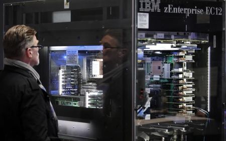 © Reuters. A man watches a server at the booth of IBM during preparations for the CeBIT trade fair in Hanover
