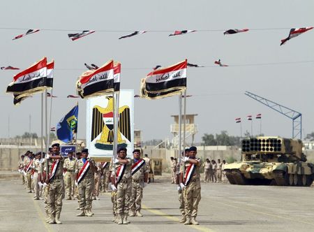 © Reuters. Iraqi Army soldiers march as part of a parade marking the founding anniversary of the army's artillery section in Baghdad