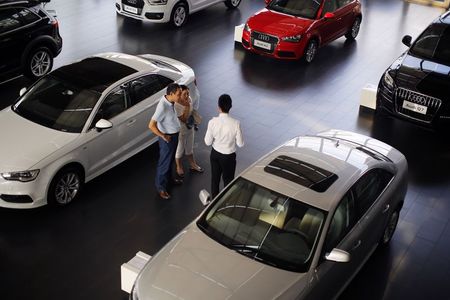 © Reuters. Customers look at cars at an Audi dealership from the Baoxin Auto Group in Shanghai