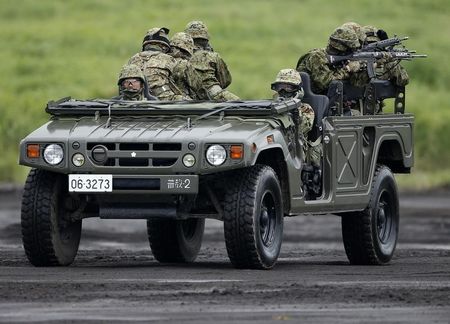 © Reuters. Japanese Ground Self-Defense Force soldiers ride on a high-mobility multipurpose wheeled vehicle (Humvee) during an annual training session near Mount Fuji at Higashifuji training field in Gotemba