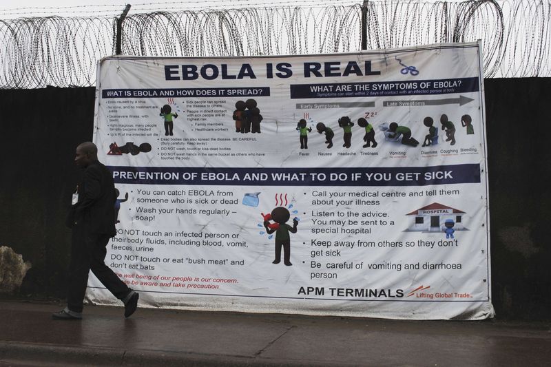 &copy; Reuters A man walks by a sign that reads &quot;Ebola is real&quot; in Monrovia