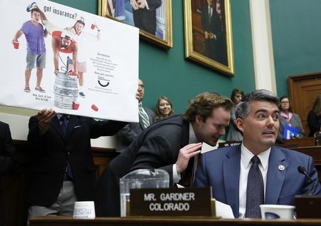 © Reuters. U.S. Representative Gardner refers to ad from a Colorado-based group called the Thanks Obamacare campaign, as he questions Sebelius during a House Energy and Commerce Committee hearing in Washington