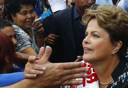 © Reuters. Brazil's President and Workers' Party presidential candidate Dilma Rousseff greets her supporters during a campaign rally in Duque de Caxias near Rio de Janeiro