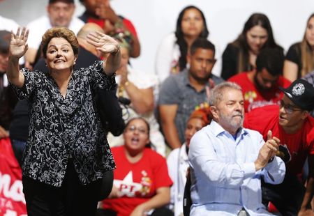 © Reuters. Brazil's President and Workers' Party (PT) presidential candidate Rousseff  waves next to Brazil's former President Luiz Inacio Lula as they attend a campaign rally in Sao Paulo