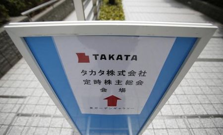 © Reuters. A sign board of Japanese auto parts maker Takata Corp's Annual General Meeting is seen on a street near the venue in Tokyo