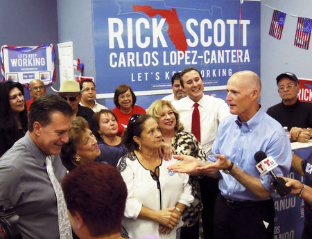 © Reuters. Florida Governor Rick Scott visits a campaign office in the Miami, Florida suburb of Hialeah, heart of the Cuban American community