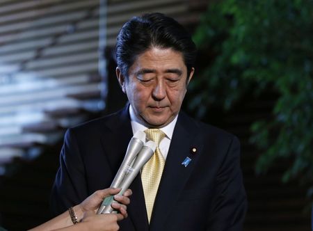 © Reuters. Japan's Prime Minister Shinzo Abe reacts as he speaks to the media at his official residence in Tokyo