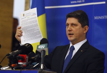 © Reuters. Romania's Foreign Minister Titus Corlatean gestures during a news conference announcing his resignation in Bucharest