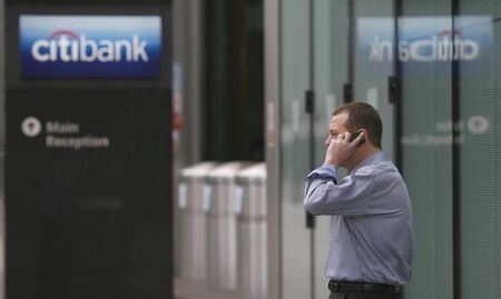 © Reuters. A man speaks on a mobile phone outside Citibank's offices in the Canary Wharf district of London