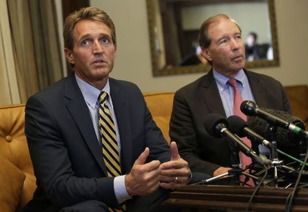 © Reuters. Flake speaks to reporters as Udall listens during a news conference in Havana