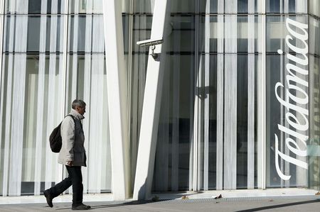 © Reuters. A man walks past a Telefonica building in Barcelona