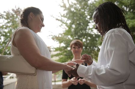 © Reuters. Kathy Stewart places a ring on the finger of her partner, Vicky Mangus, during a wedding ceremony outside of the Mecklenburg County Register of Deeds office in Charlotte