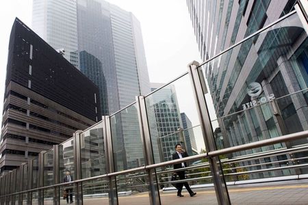 © Reuters. A man walks at the Shiodome business district in Tokyo