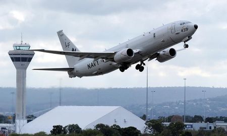 © Reuters. A U.S. Navy P-8 Poseidon aircraft takes off from Perth International Airport to participate in the search for the missing Malaysian Airlines flight MH370