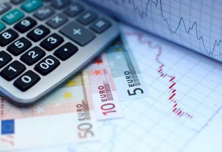 © Reuters. Euro banknotes coins and a calculator are placed on a currency graph and ticker in picture illustration taken in Zenica