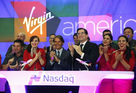 © Reuters. Virgin America Inc. President and Chief Executive Officer Cush rings the opening bell of the trading session as Virgin America Inc. celebrated its initial public offering at the NASDAQ Market Site in New York