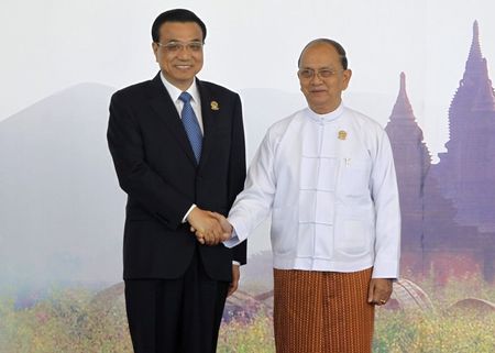 © Reuters. China's Premier Li shakes hands  with Myanmar president Thein Sein as he arrives for EAS plenary session during ASEAN Summit in Naypyitaw