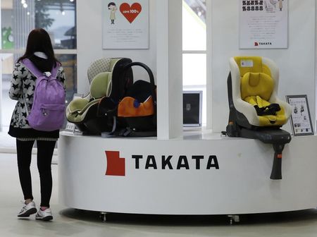 © Reuters. Visitor walks past displays of Takata Corp at a showroom for vehicles in Tokyo